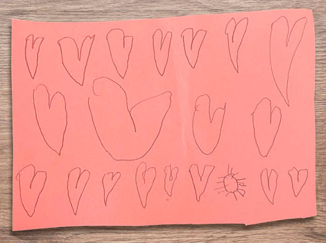 children's drawing of hearts on construction paper